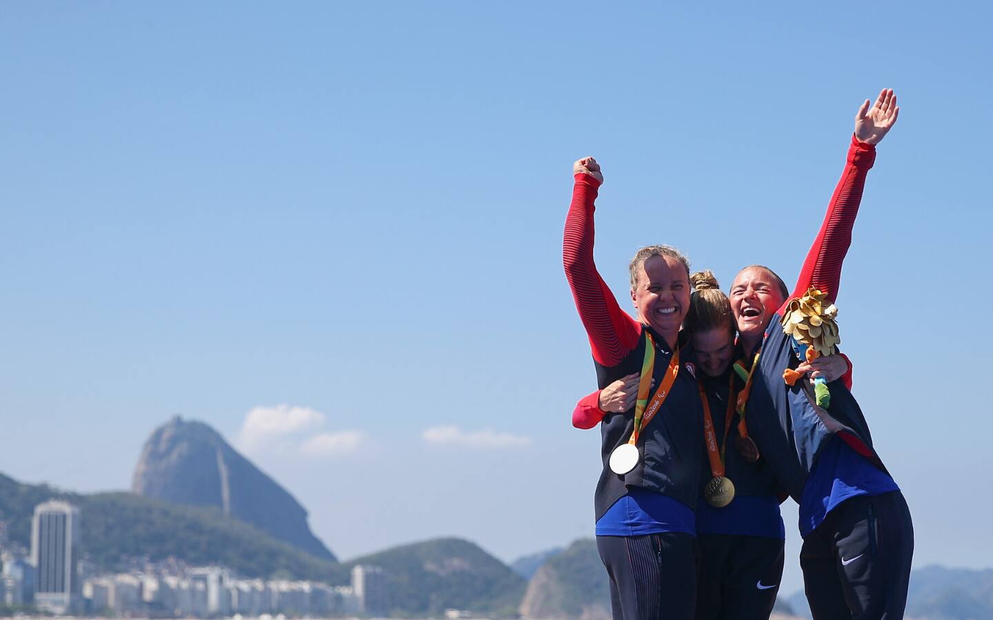 Paralympic triathletes celebrate medals in Rio 2016.