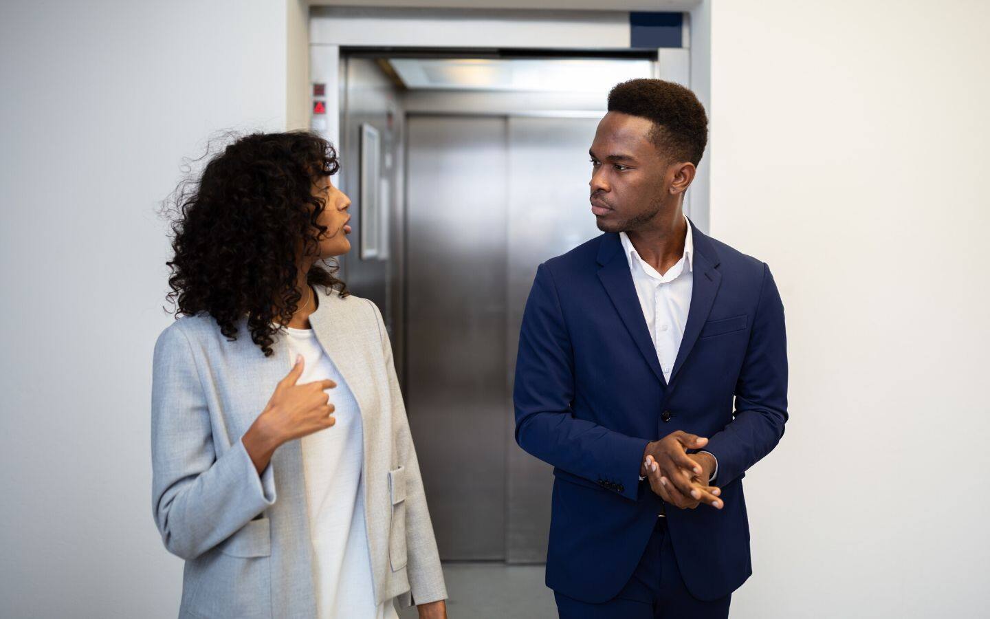 Two people talking in elevator