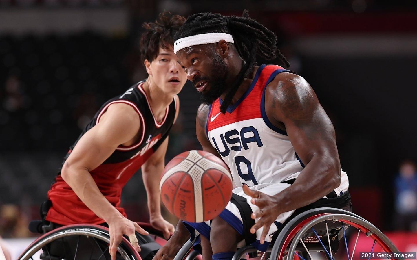 U.S. Wheelchair Basketball athlete Matt Scott dribbles ball against opponent