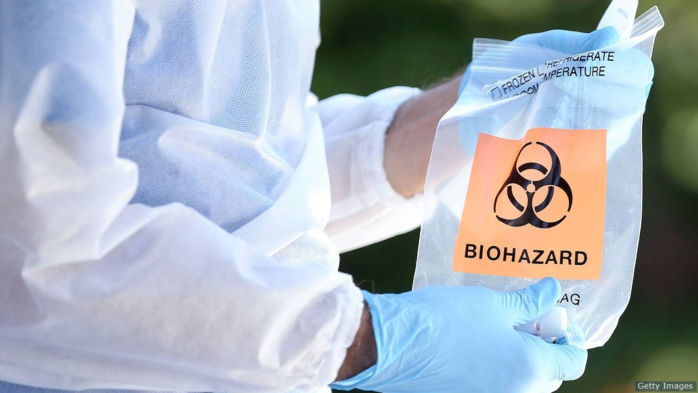 A medical professional holds a COVID-19 test.