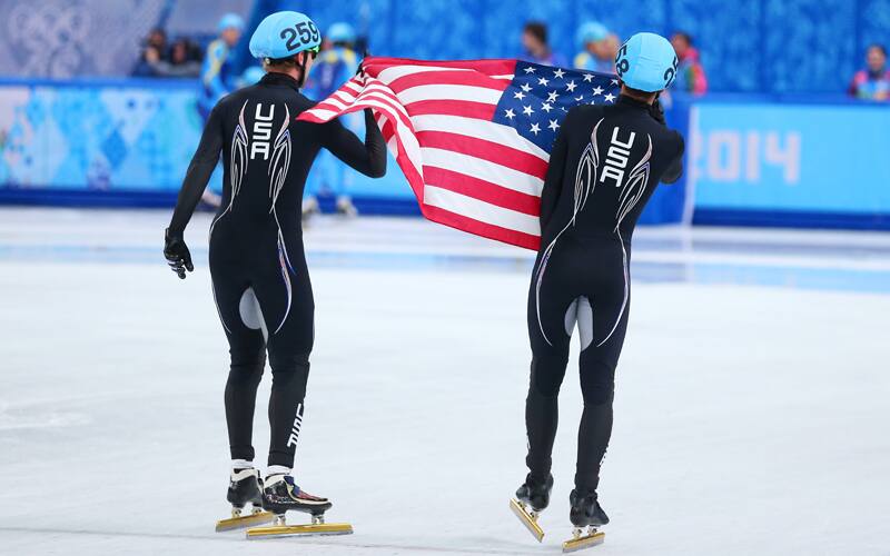 J.R. Celski celebrates a silver medal with teammate Chris Creveling at the Sochi 2014 Olympic Winter Games.