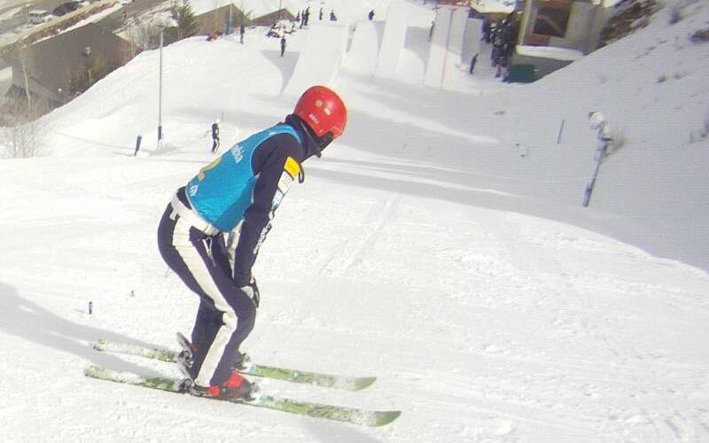 Alex Bowen looks down ski slope prior to beginning his run.