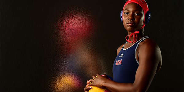 Donning her Team USA water polo uniform, Ashleigh Johnson poses for a photo in the studio.