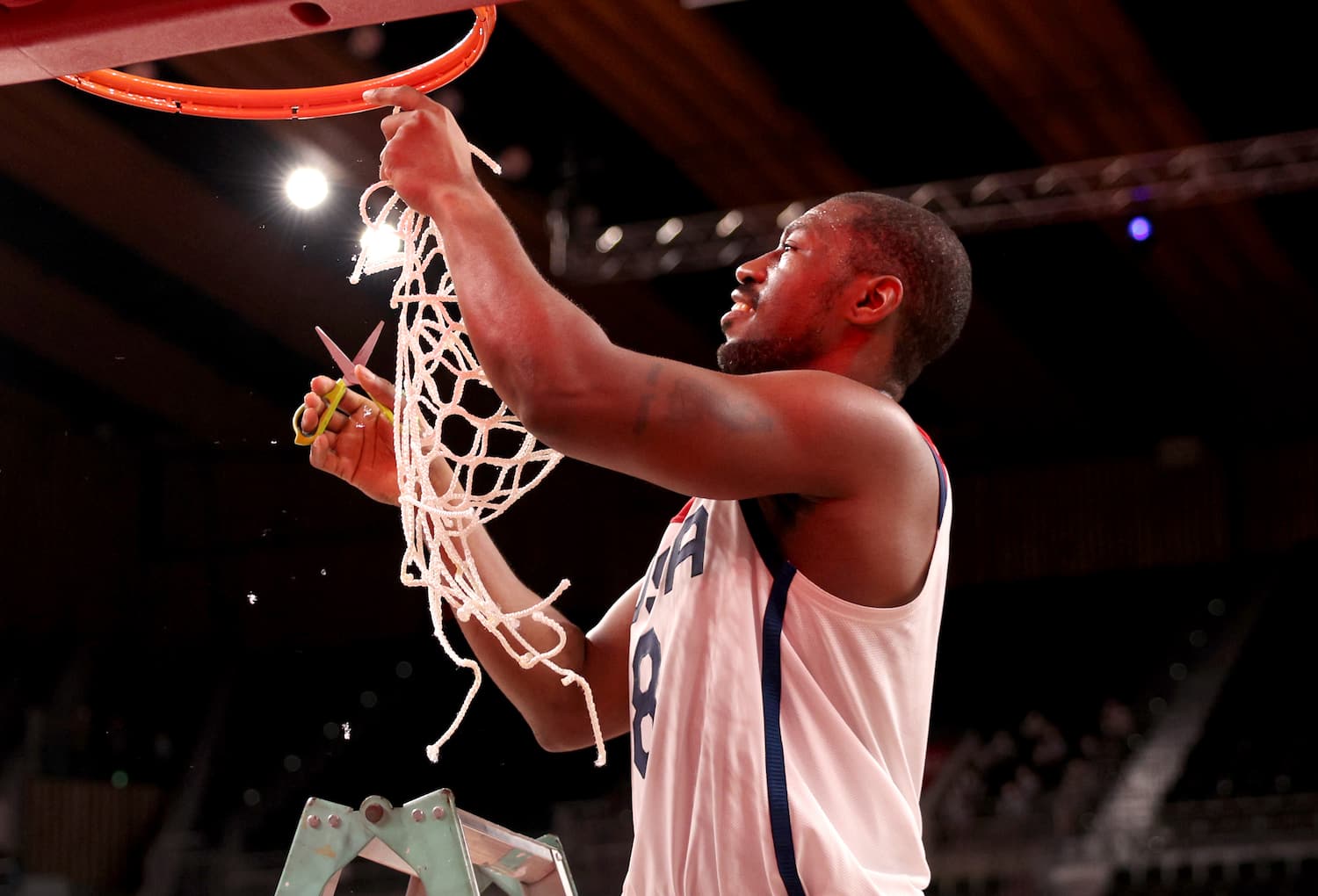 Brian Bell cuts down the net after Team USA wins gold in men's wheelchair basketball at the Tokyo Paralympics
