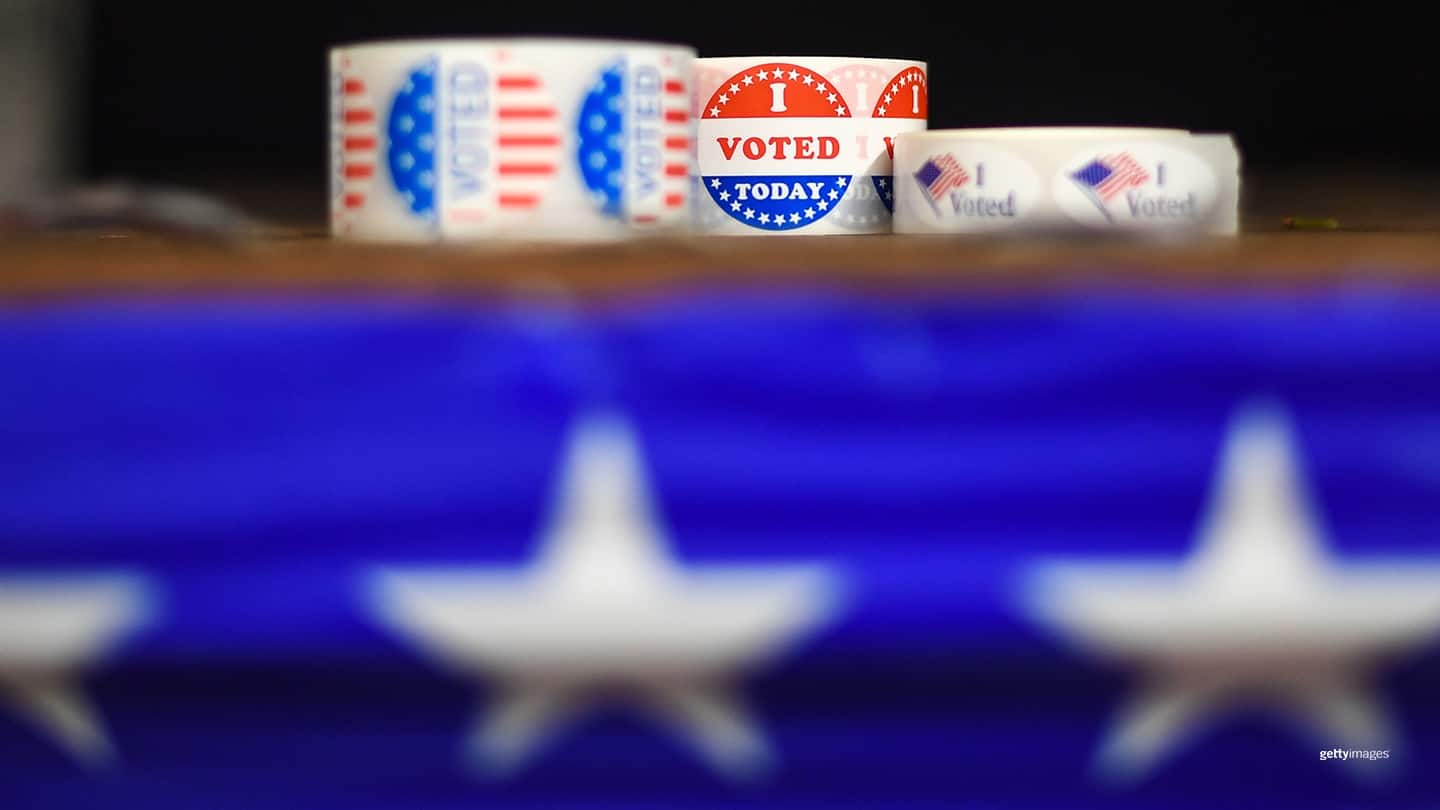 Rolls of "I Voted" stickers sit on top of a table. 