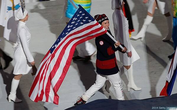 Julie Chu carries the flag in the closing ceremonies