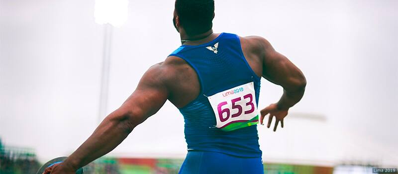 While competing in the men's discuss final, Reggie Jagers faces away from the camera, holding his discus as he spins. 
