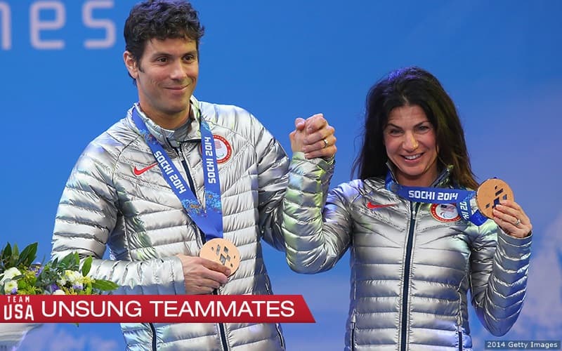 Rob Umstead and Danelle Umstead hold hands on podium at 2014 Paralympics.