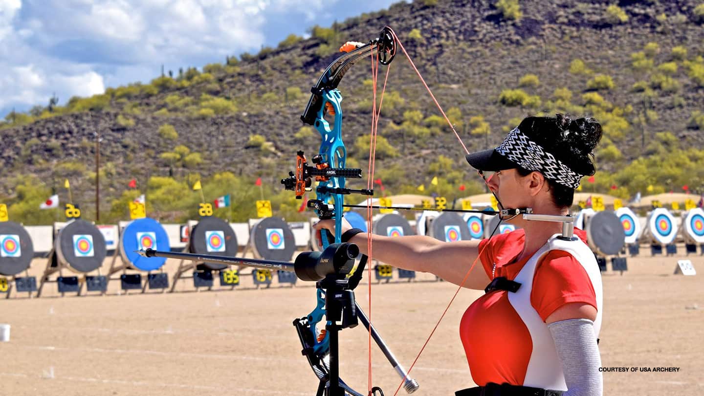 Sam Tucker aims her bow at the target at a USA Archery event. 