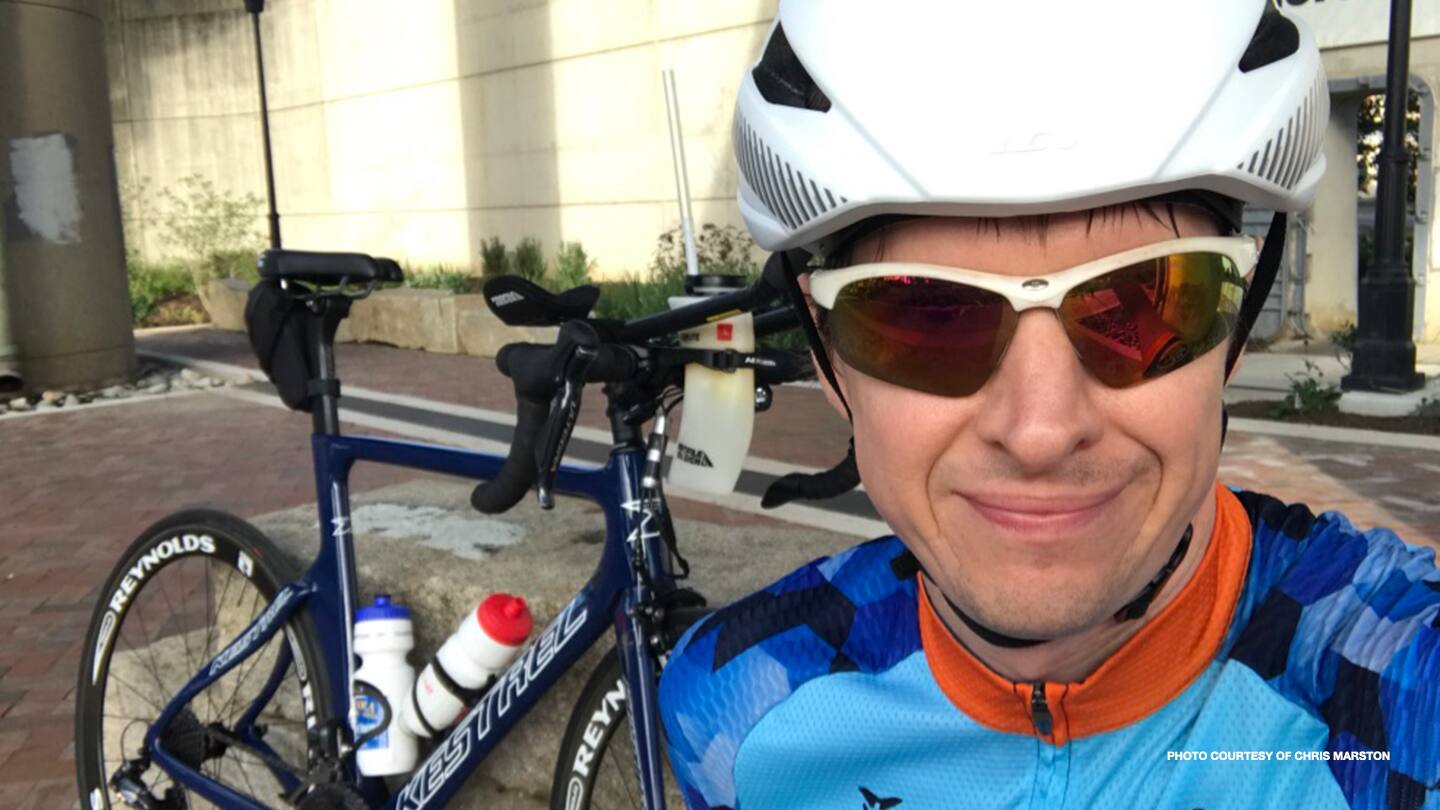 Chris Marston smiles in a selfie with his bike. 
