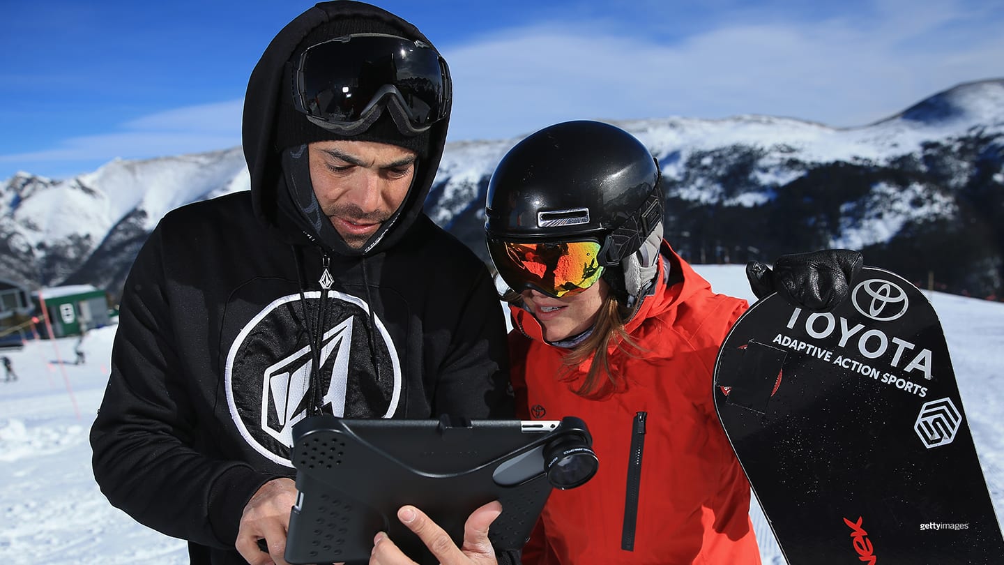 Amy Purdy reviews a video of her run with her husband Daniel Gale, Executive Director and co-founder of Adaptive Action Sports, during a training session on December 18, 2013 in Copper Mountain, Colorado.
