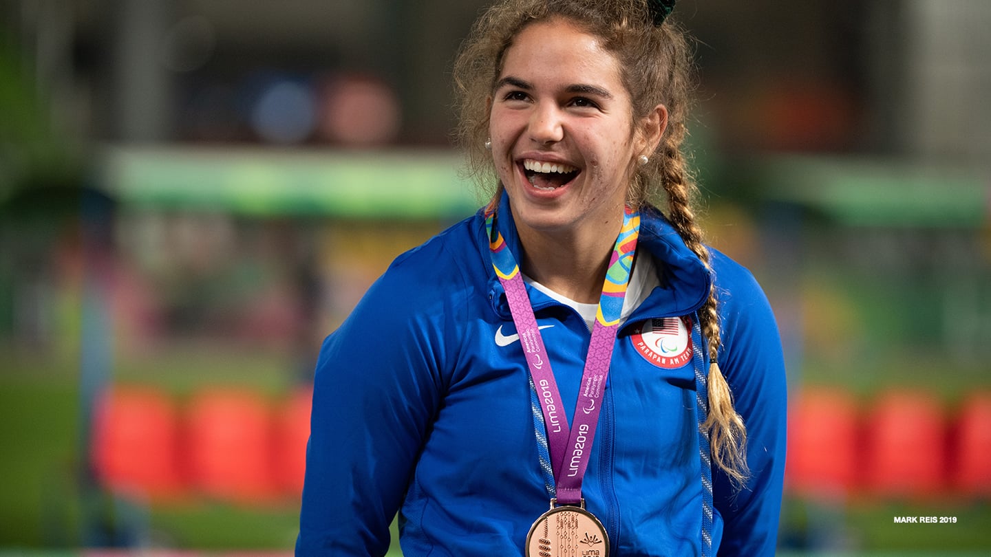 Sydney Barta smiles atop the podium at the Lima 2019 Parapan American Games. 