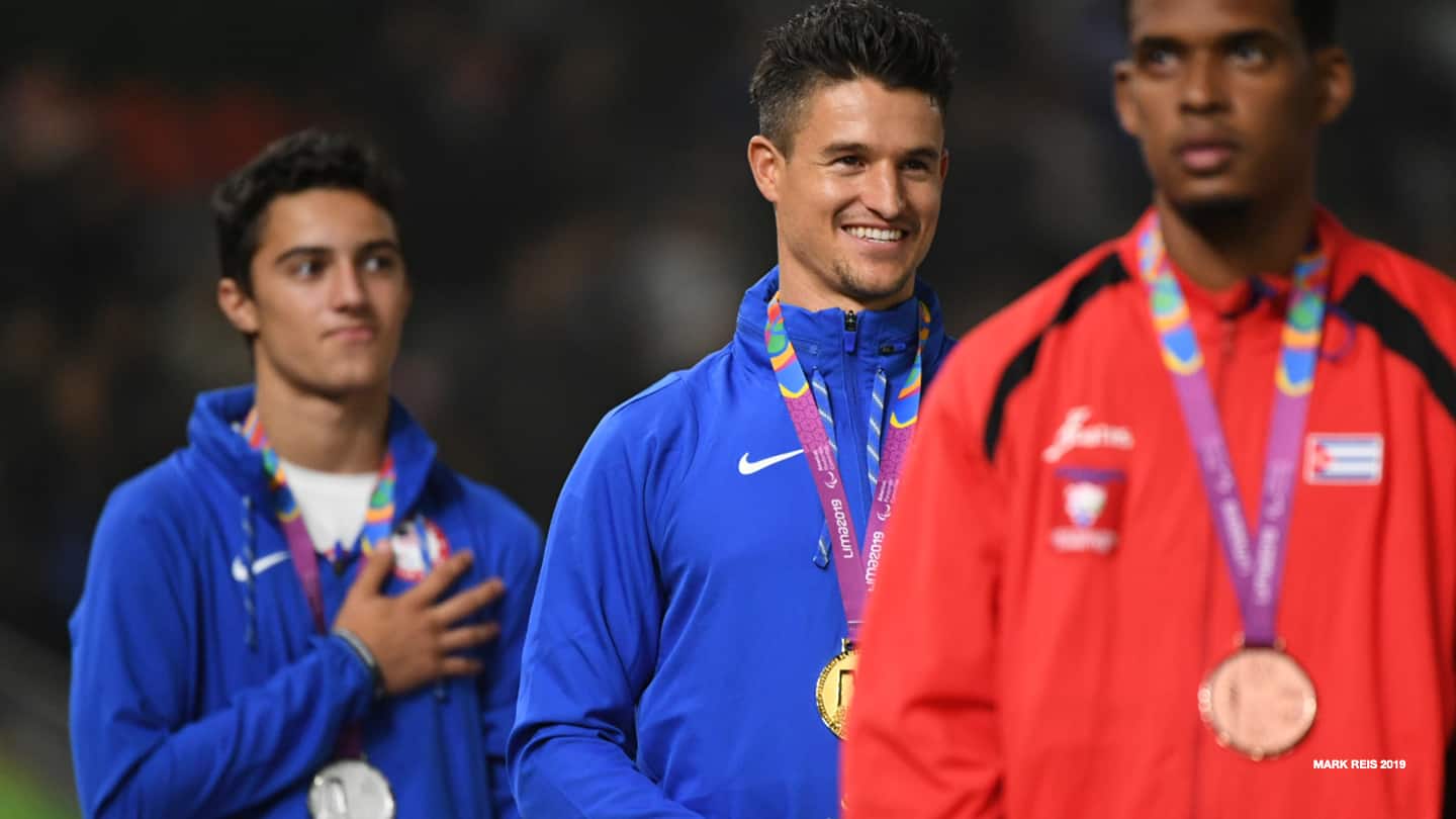 Trenten Merrill smiles on the podium with teammate Ezra Frech after winning the gold at the 2019 Parapan American Games in Lima, Peru. 