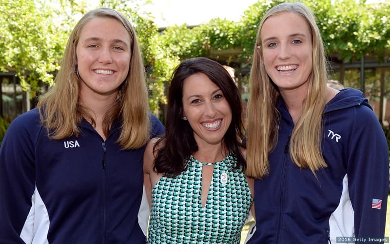 Former Olympian Janet Evans smiles alongside U.S. Olympic Women's Water Polo Team members, and sisters, Makenzie and Aria Fischer.