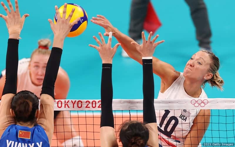 Jordan Larson of of the U.S. women's volleyball team rises above the net to spike the ball against China during the 2020 Olympic Games.