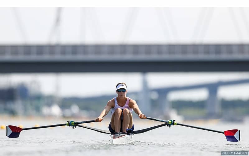 U.S. Rower Kara Kohler faces the camera while rowing during competition.