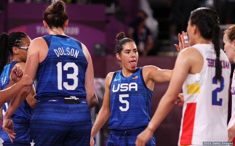 U.S. 3x3 basketball player Kelsey Plum high fives a teammate during competition.