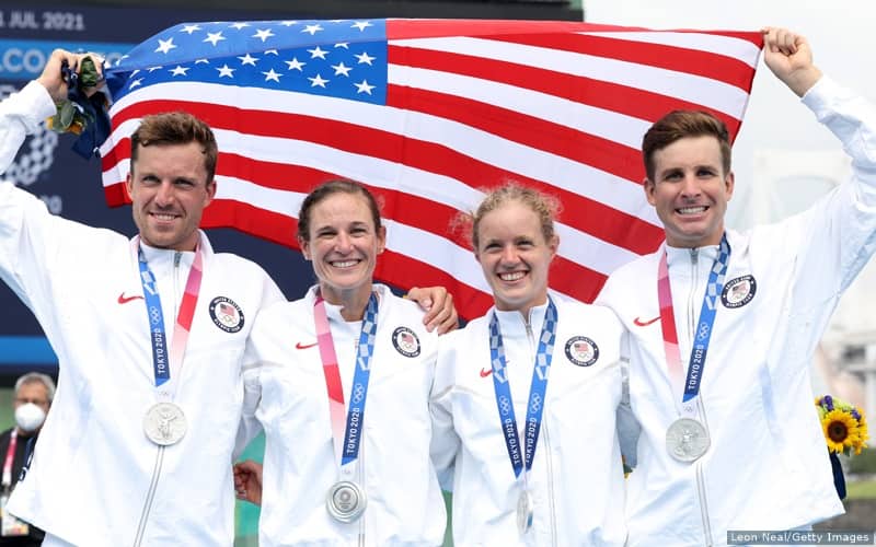 Morgan Pearson, Katie Zaferes, Taylor Knibb and Kevin McDowell pose with the American flag and their silver medals following the mixed relay triathlon at the 2020 Olympic Games.