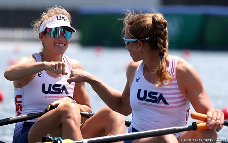 Rowers Gevvie Stone and Kristi Wagner bump fists in celebration after a race.