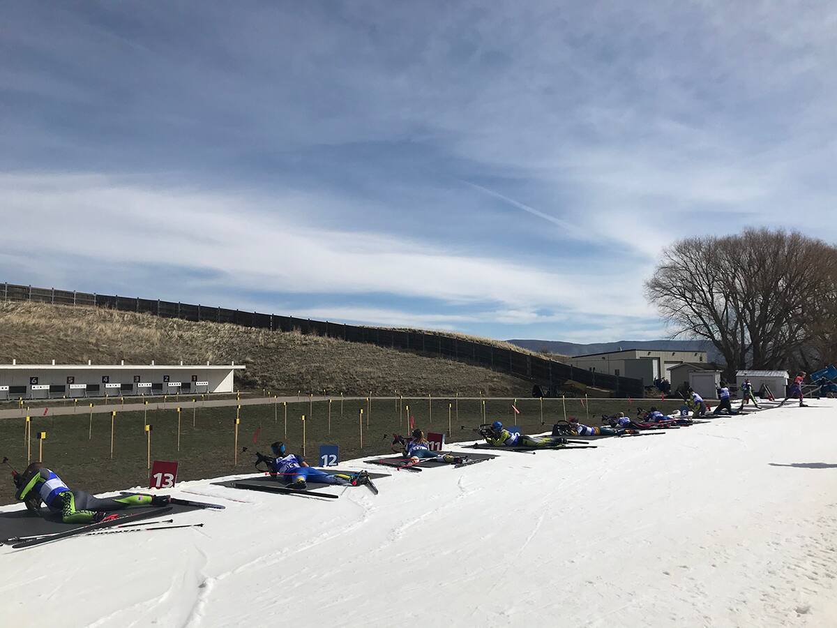 Biathletes on the range in prone