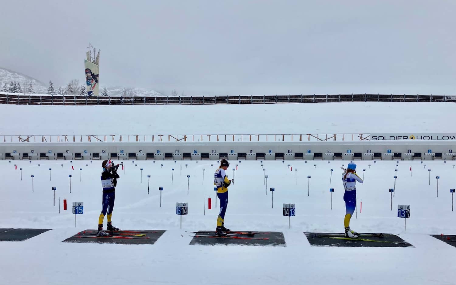 Three athletes on the shooting range at the Soldier Hollow venue
