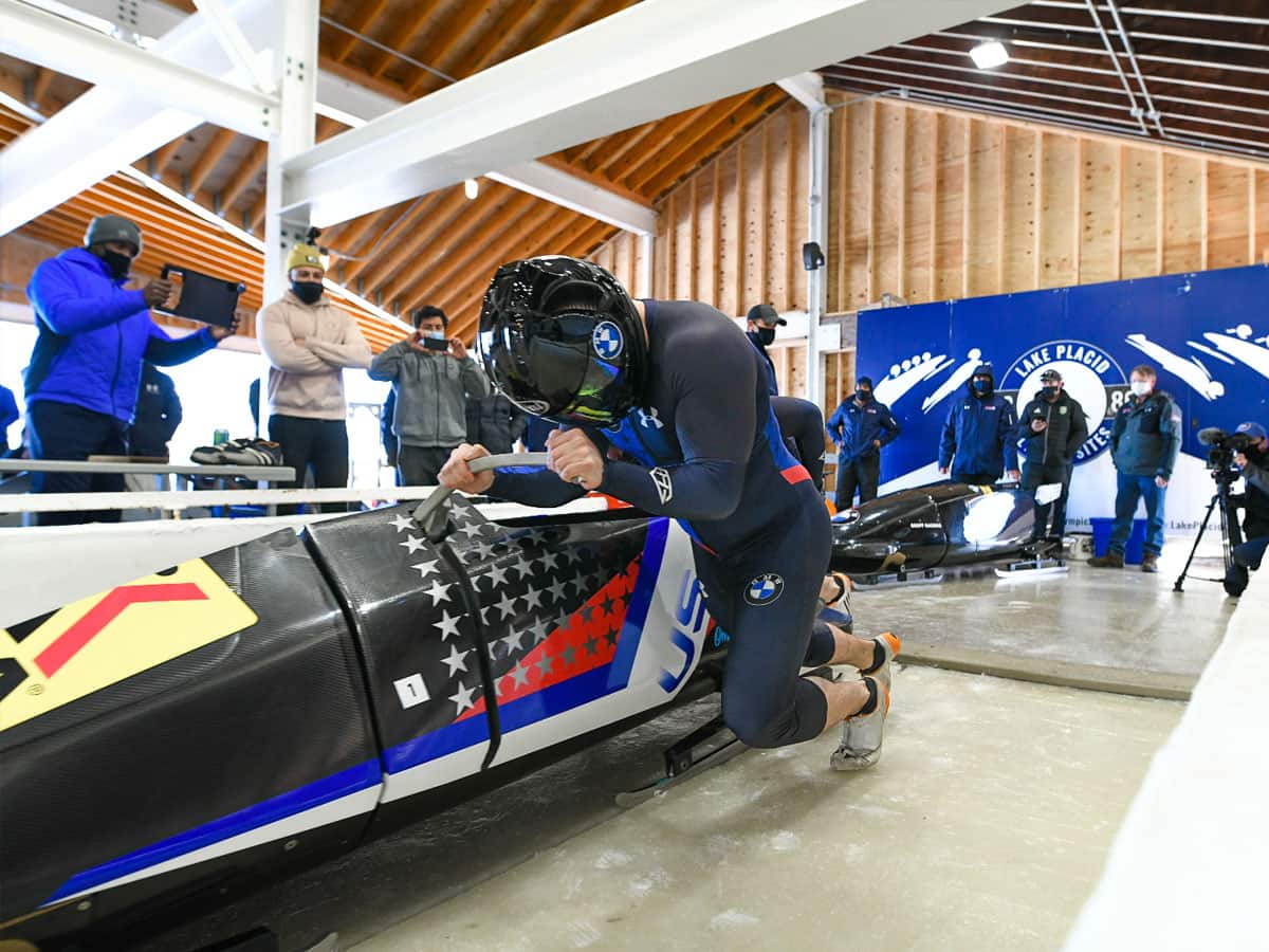 Codie Bascue and Carlo Valdes pushing the sled off the start