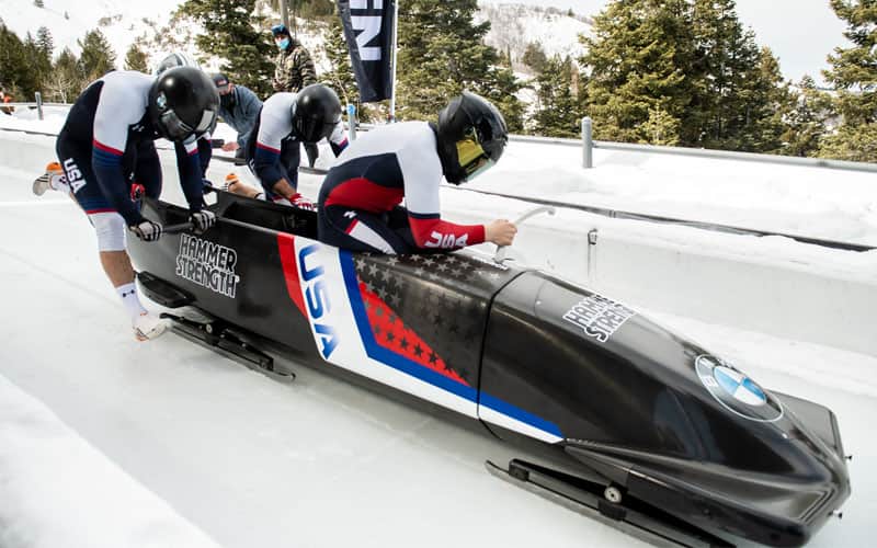Team Church pushes a Hammer Strength branded sled