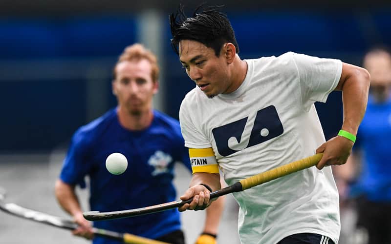 A male athlete dribbles the ball in the air during the 2017 United States Field Hockey League Adult National Championship at Spooky Nook Sports in Lancaster, Pennsylvania