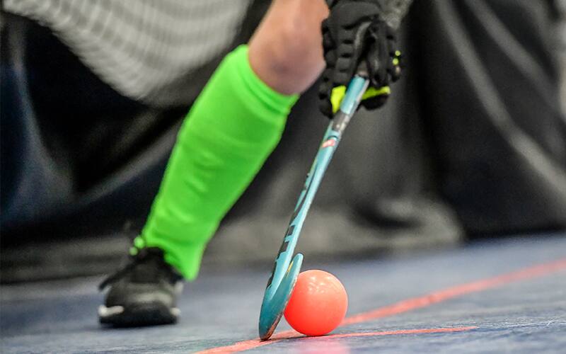 Stock image of an athlete with ball and stick