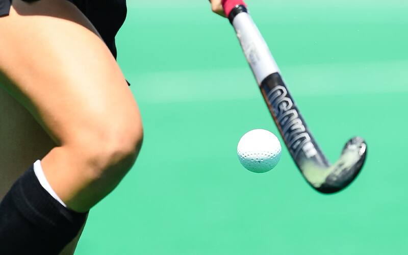 Stock image of a field hockey stick and ball