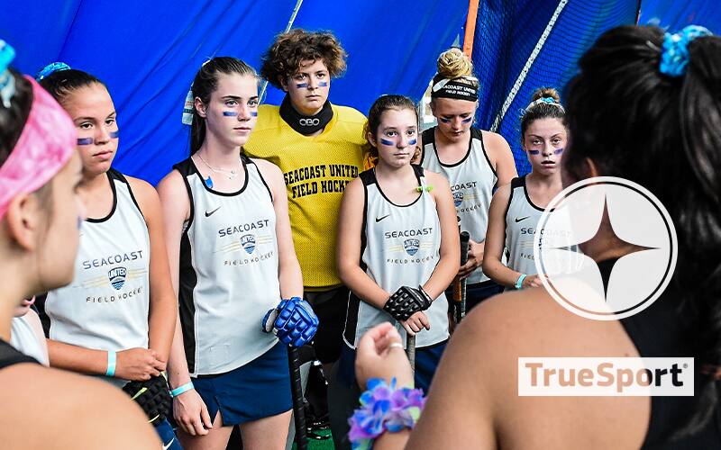 Seacoast United players on the sideline with TrueSport logo