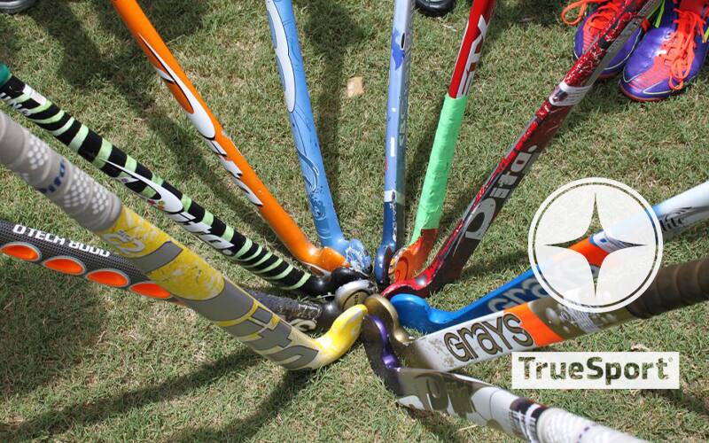 Field hockey sticks with the TrueSport logo