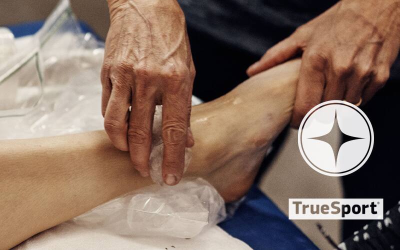 Athlete icing her ankle with TrueSport logo