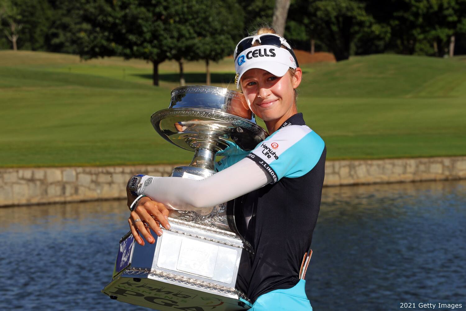 Nelly Korda hoists the trophy after the KPMG Women's PGA Championship. 