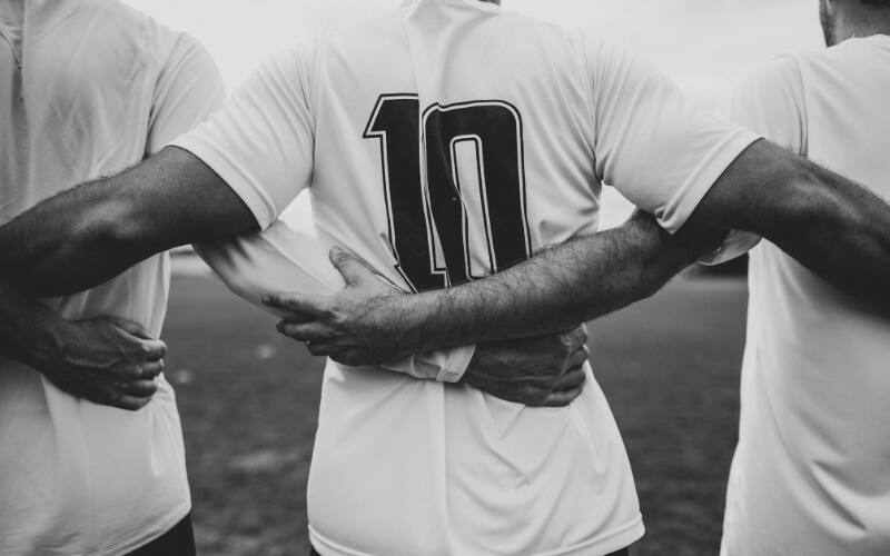 Athletes with arms around one another