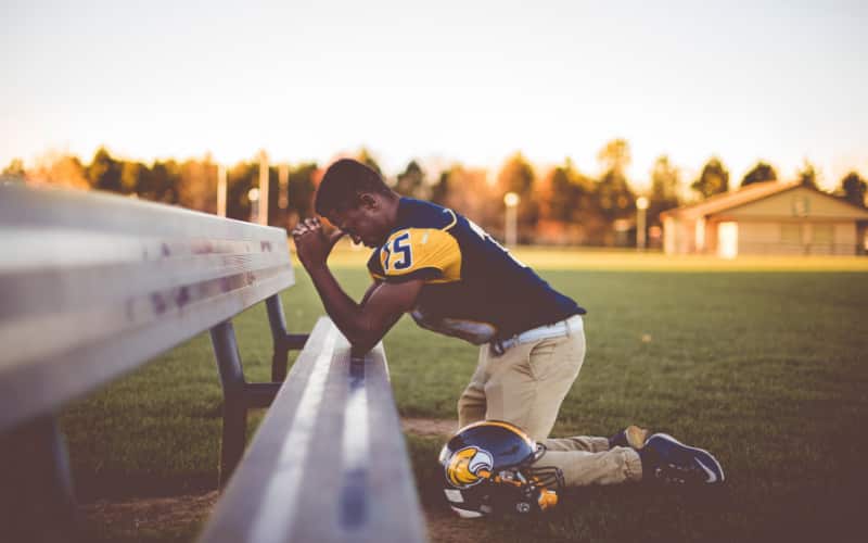 Athlete leaning over bench image
