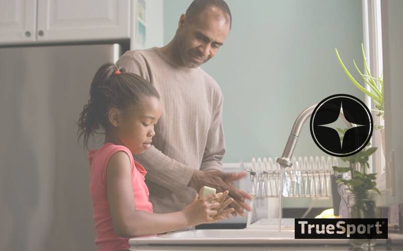 Father and daughter washing hands