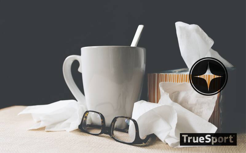 Orange Striped Box of Tissues, White Ceramic Mug , Black Glasses, black background 