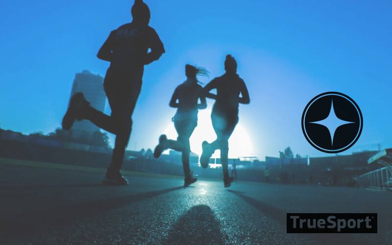 Athletes Running Silhouetted With Heavy Blue Hue 