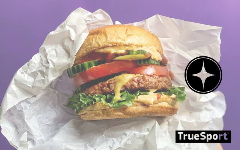 Plant Based Burger on White Wrapper with a bright purple background