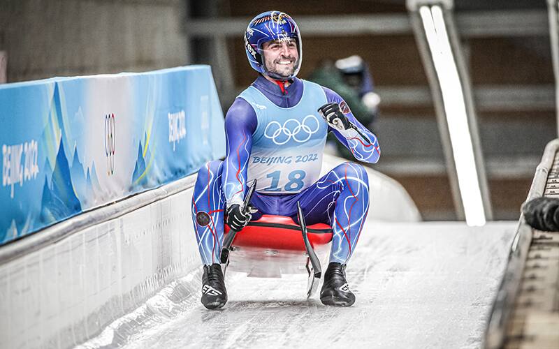 Chris Mazdzer celebrates after finishing 8th at the 2022 Olympic Games 