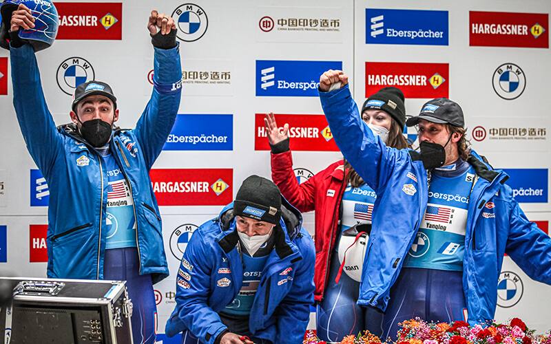 Chris Mazdzer, Tucker West, Ashley Farquarahson and Jayson Terdiman celebrate their silver medal in Yanqing, China on November 21, 2021