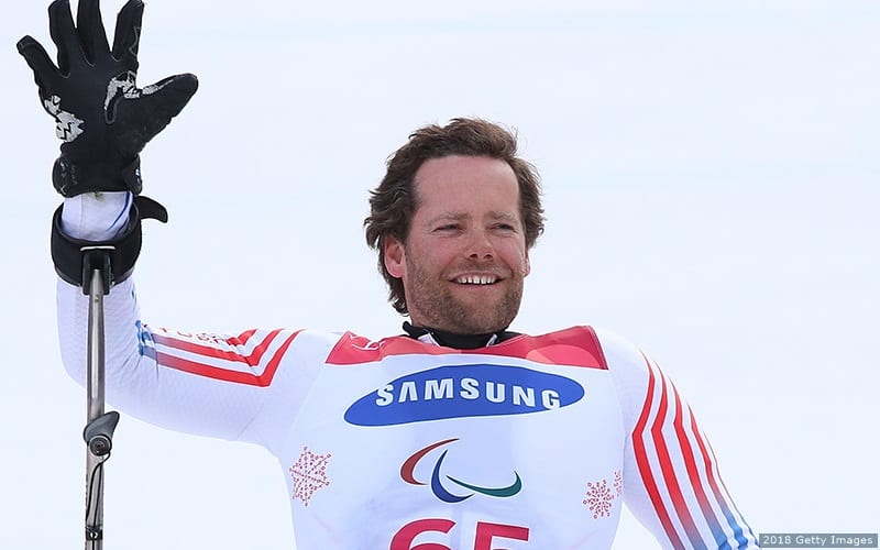 Para alpine skier Tyler Walker waves to the crowd after a run.