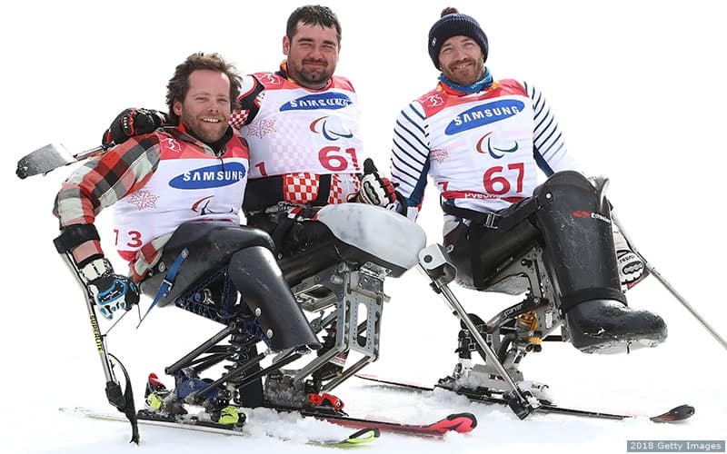 Para alpine skier Tyler Walker poses with two fellow skiers for a group photo.