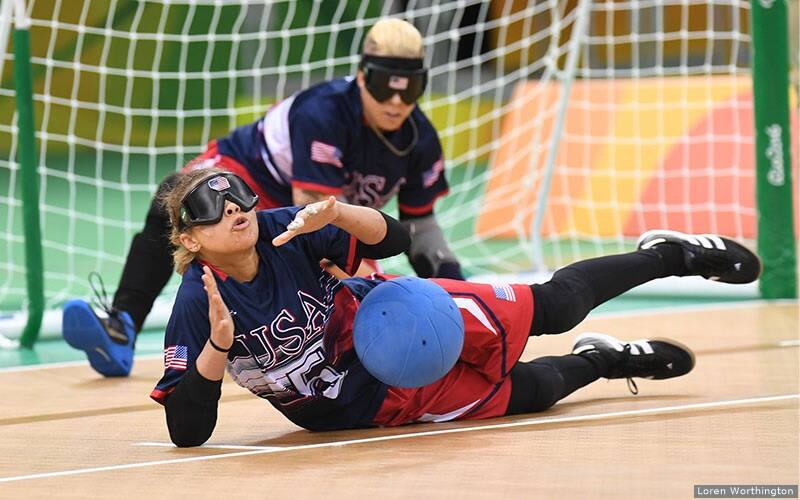 Amanda Dennis blocks a ball during a goalball match.