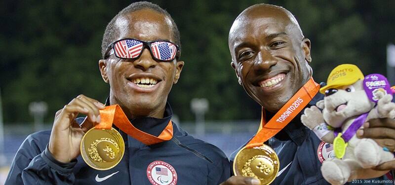 Track and field athletes David Brown and Jerome Avery smile after winning gold medals in Toronto at the 2015 Parapan American Games.