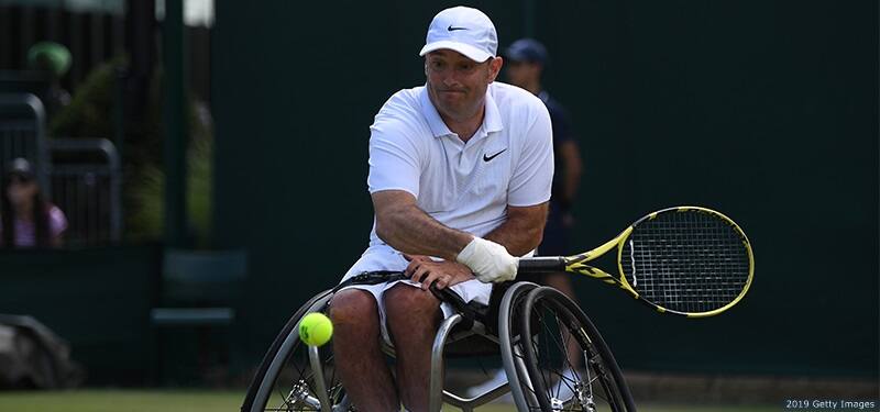 David Wagner returns a serve in wheelchair tennis at the Wimbledon championships in London, England.
