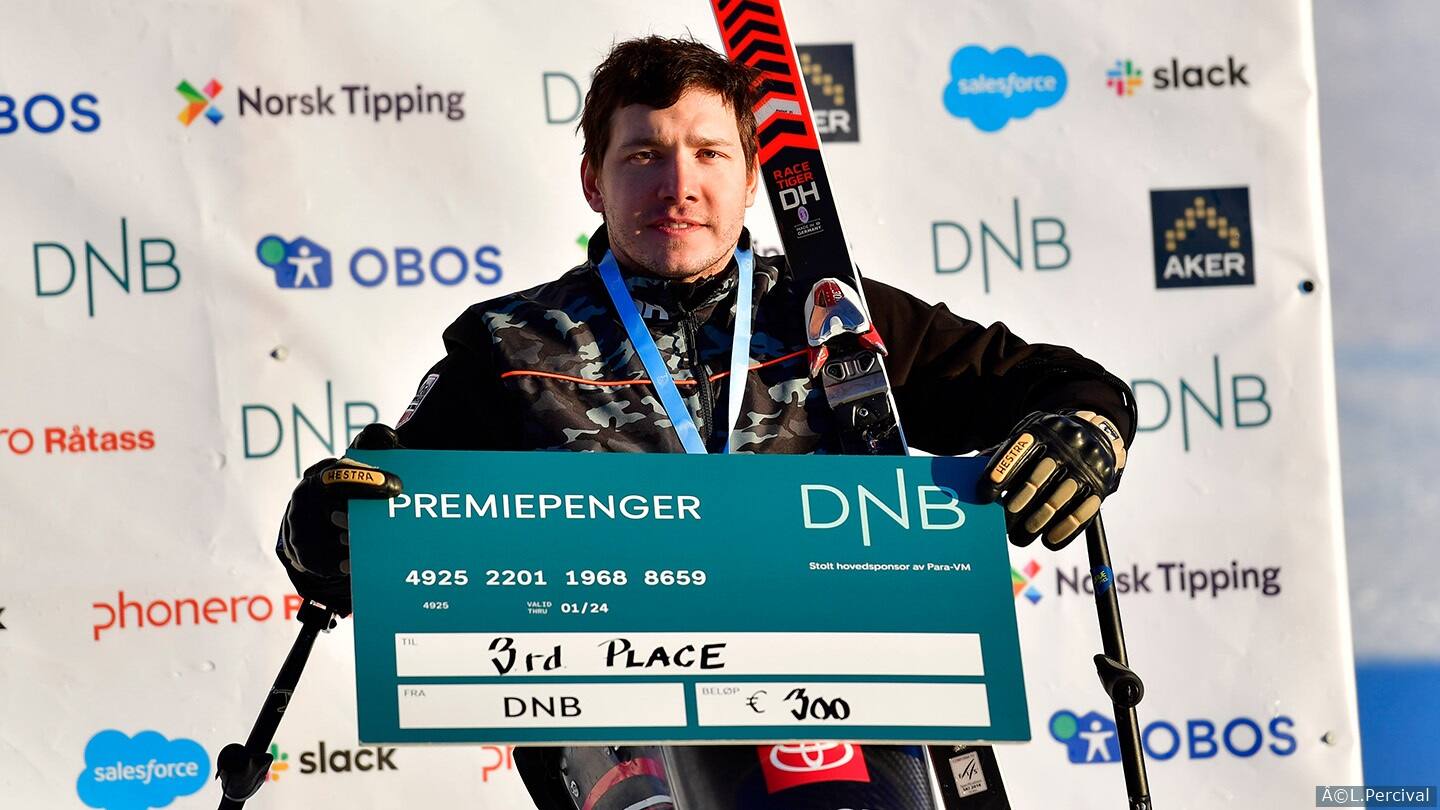 Andrew Kurka poses on podium after bronze win. 