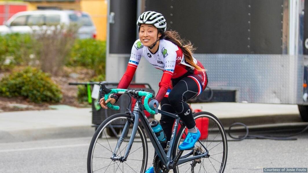 Josie Fouts smiles while riding bike. 