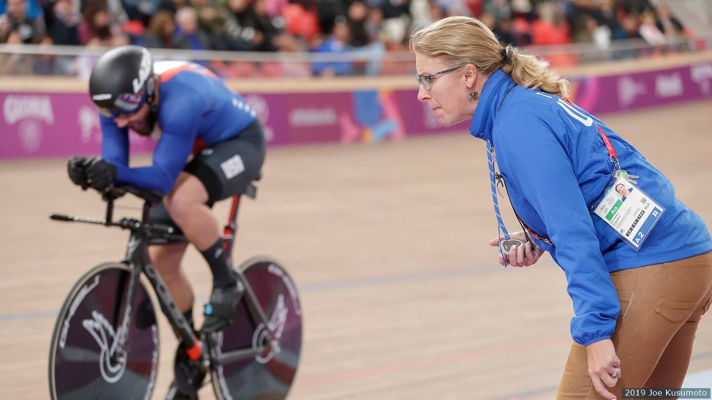 Sarah Hammer on the track with cyclist during competition. 